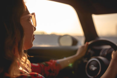 Close-up of woman driving car