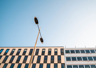 Low angle view of street light against building