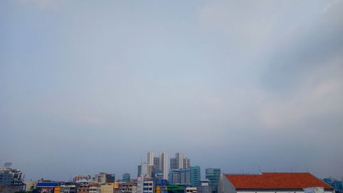 High section of buildings in city against sky