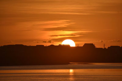 Scenic view of sea against orange sky during sunset