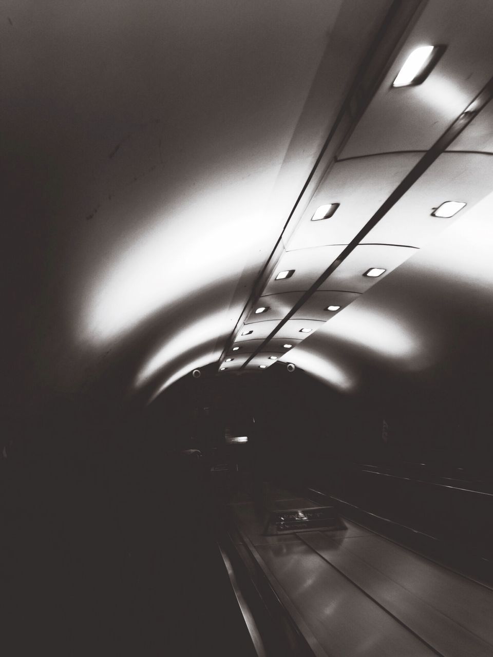 indoors, transportation, illuminated, mode of transport, ceiling, lighting equipment, airplane, vehicle interior, travel, technology, public transportation, no people, on the move, diminishing perspective, journey, the way forward, modern, air vehicle, tunnel, low angle view