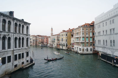 High angle view of boats rowing on grand canal amidst buildings against sky