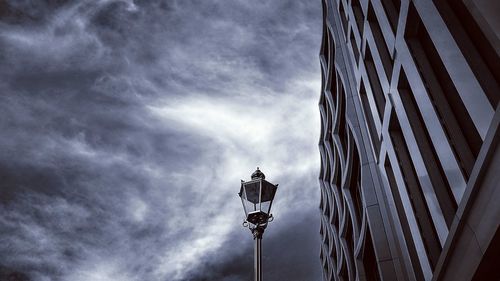 Low angle view of street light against building