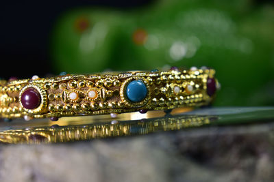 Close-up of golden bangle on table