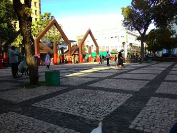 People walking on footpath in city