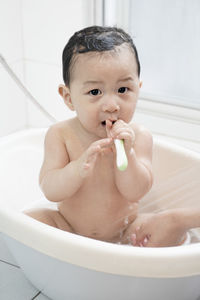 Portrait of baby boy in bathroom