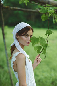 Portrait of young woman holding flower