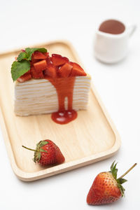 Close-up of strawberries in plate on cutting board