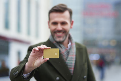 Portrait of smiling young man using mobile phone