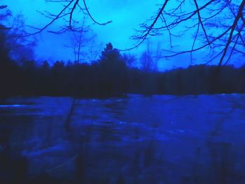 Scenic view of lake against sky during winter