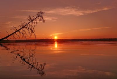 Scenic view of lake against romantic sky at sunset