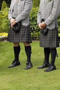 Low section of men standing with umbrella