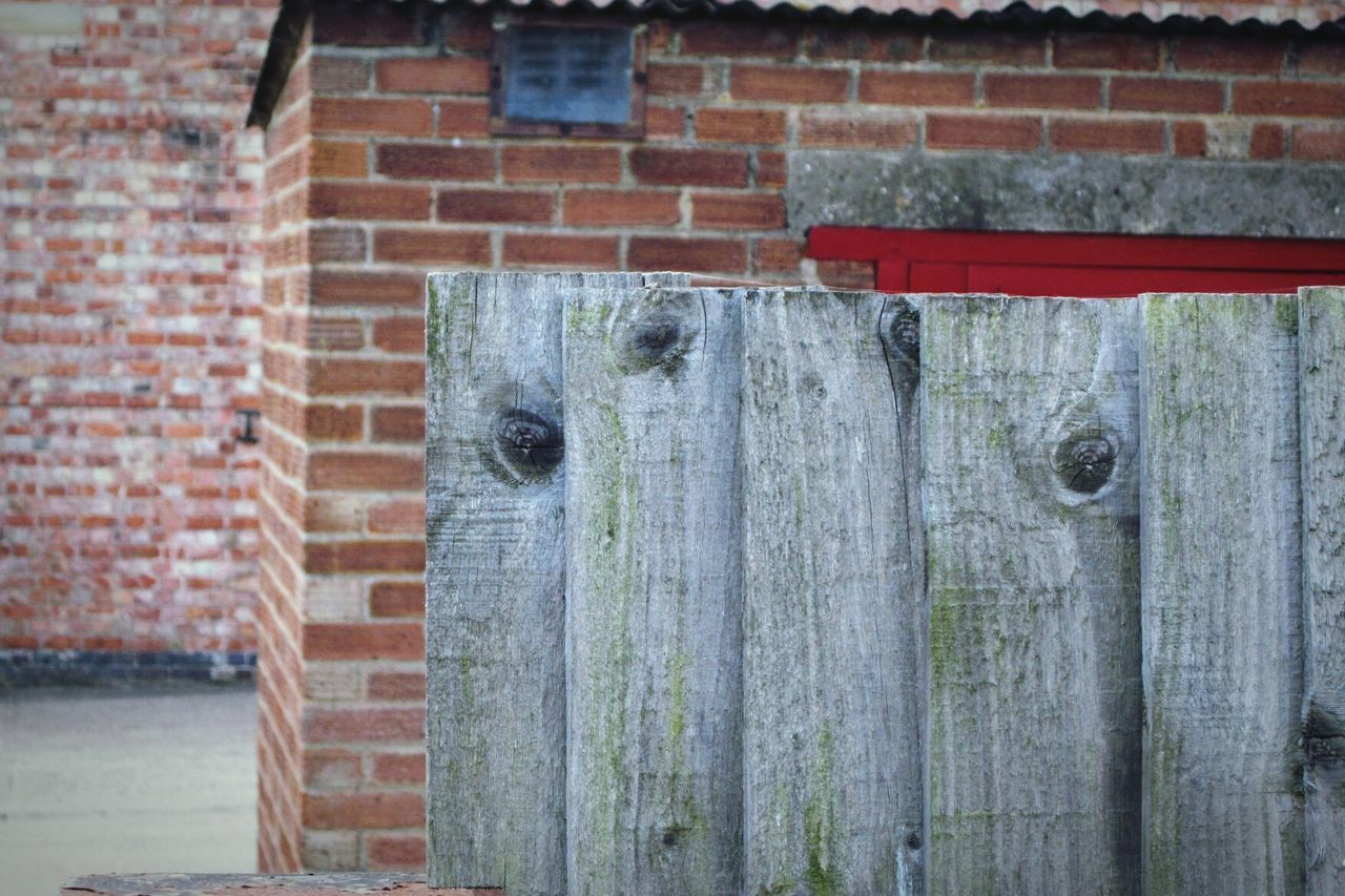 CLOSE-UP OF WEATHERED WALL WITH OLD BUILDING