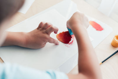 Cropped hand of woman holding strawberry