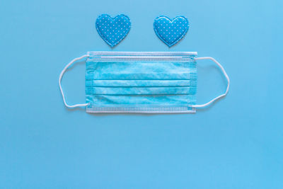 High angle view of heart shape on table against blue background