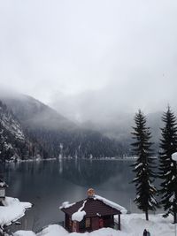 Scenic view of lake by snowcapped mountains against sky