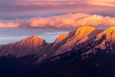 Scenic view of snowcapped mountains against sky during sunset