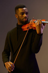 Man playing violin against white background