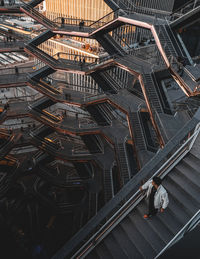 High angle view of man walking on staircase of building