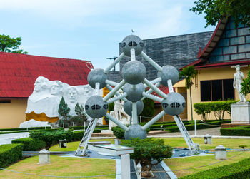 View of statue in garden against building