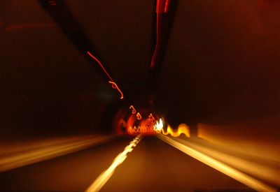 Illuminated tunnel at night