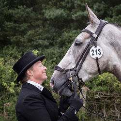 Side view of man with horse