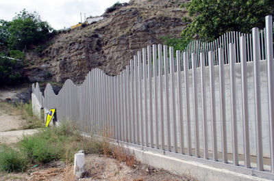 Metallic fence against mountain