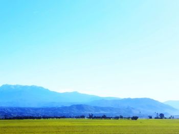 Beautiful blue sky over green landscape with smoky mountains 