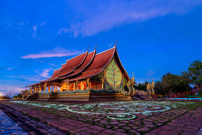 Temple outside building against blue sky