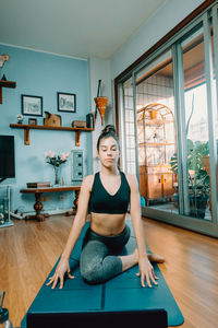 Portrait of young woman exercising in gym