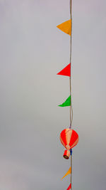 Low angle view of flags hanging against sky