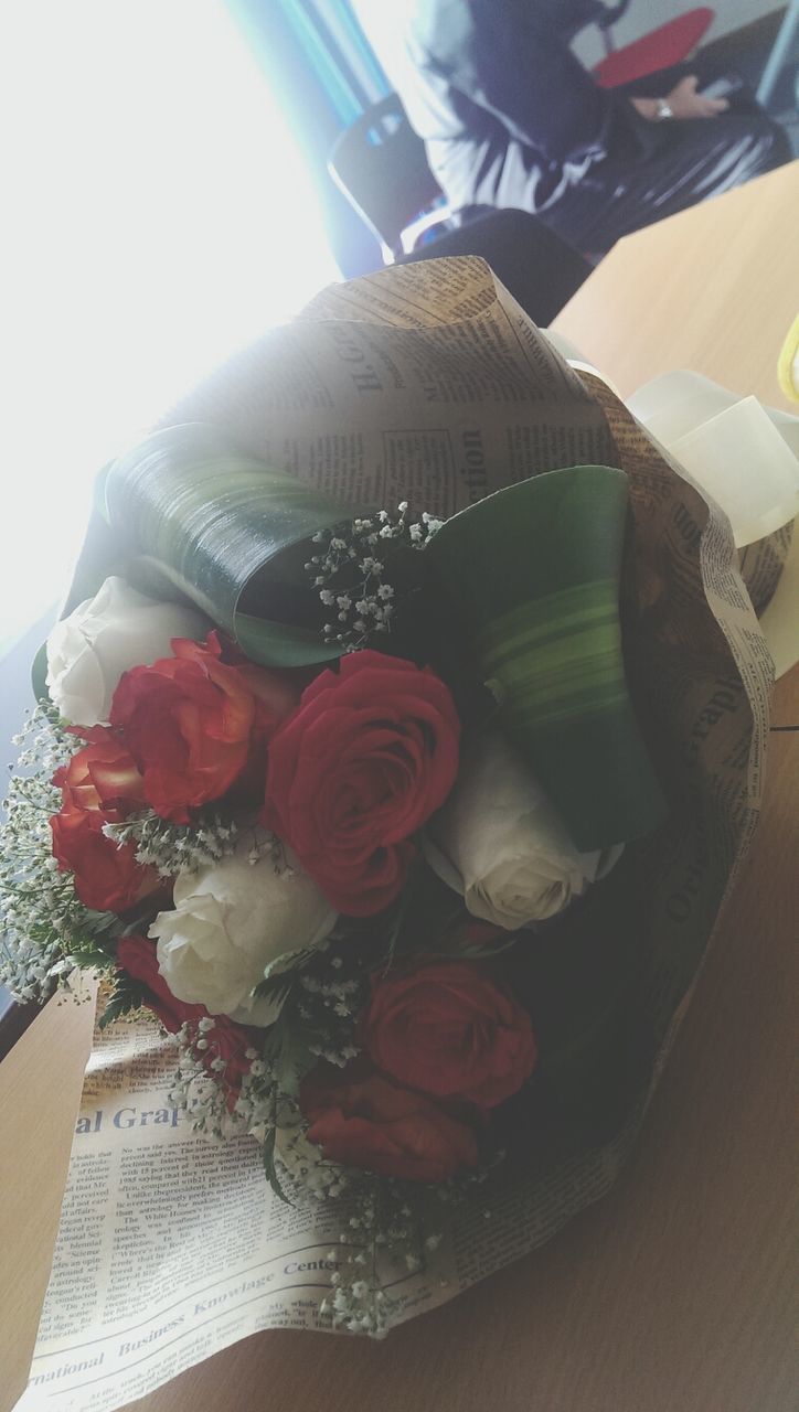 indoors, flower, table, home interior, high angle view, freshness, rose - flower, vase, fragility, close-up, still life, petal, decoration, no people, white color, pink color, bouquet, red, glass - material, sunlight