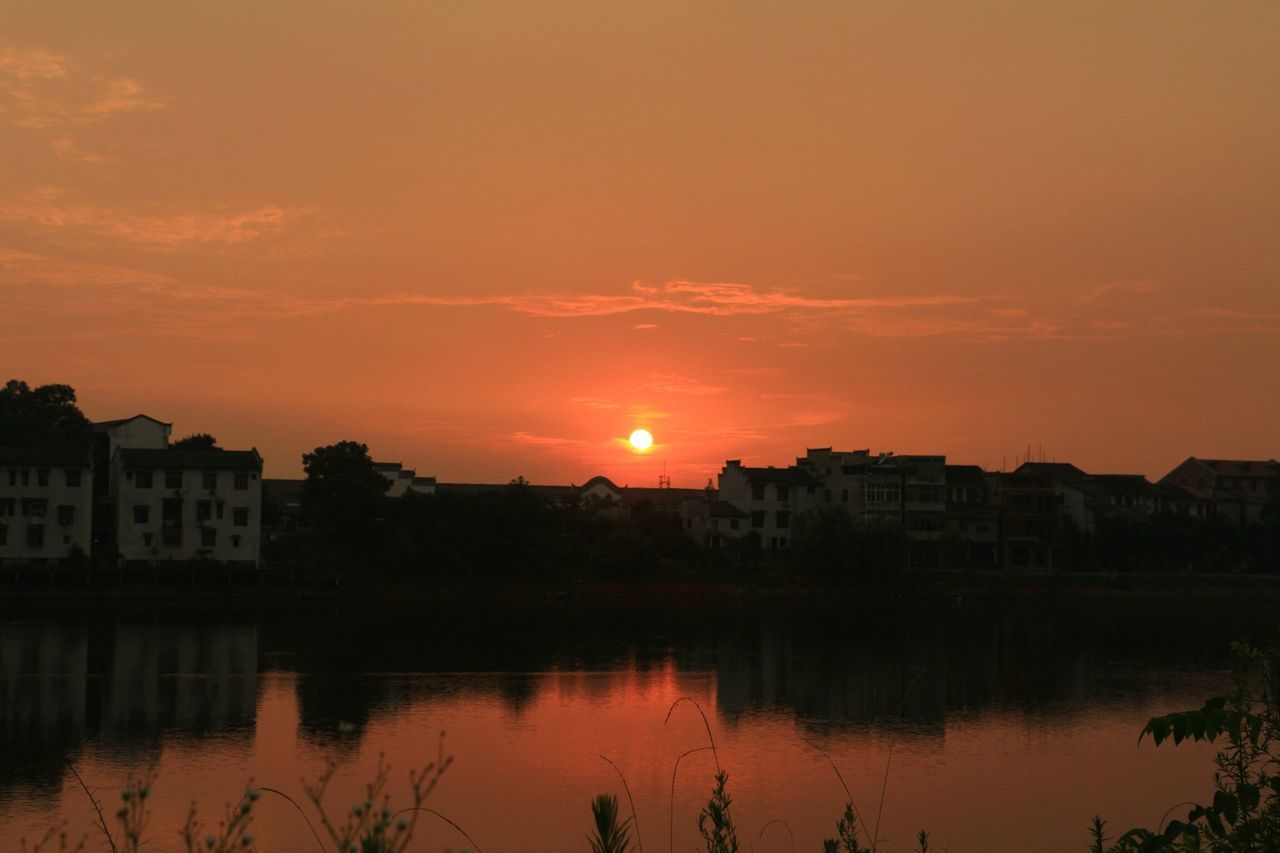 sunset, building exterior, architecture, built structure, water, orange color, reflection, waterfront, sky, sun, house, residential structure, river, residential building, lake, city, scenics, beauty in nature, nature, building