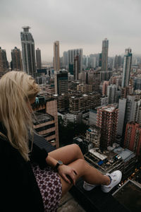 Midsection of man in city against sky