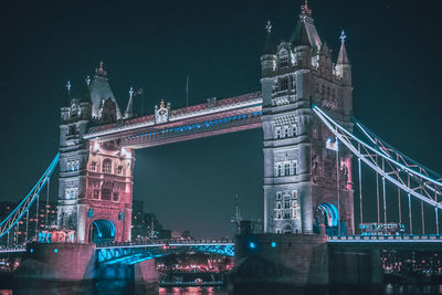 Low angle view of suspension bridge at night