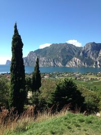 Scenic view of landscape and mountains against blue sky