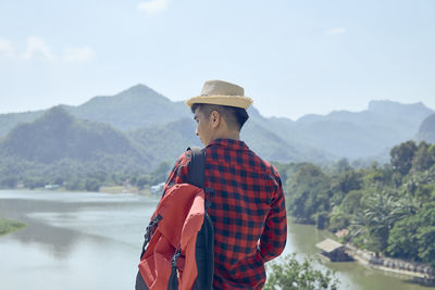 Man standing by mountain against sky