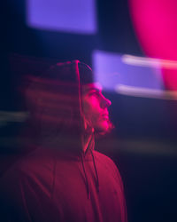 Close-up of thoughtful man wearing cap in illuminated room