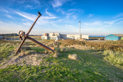 Abandoned building on field against sky