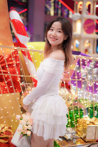 Portrait of young woman standing in store