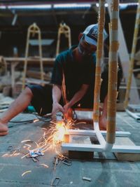 Workers use a grinder to make a product