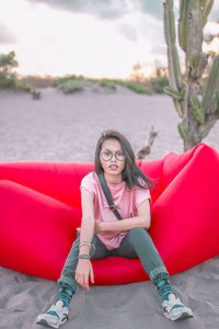 Portrait of smiling young woman sitting outdoors