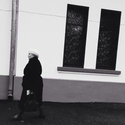 Full length of woman standing by railing