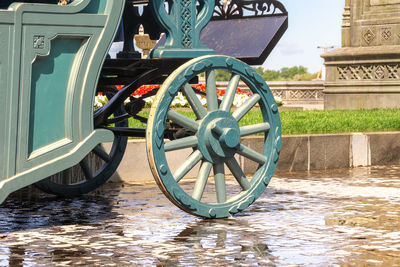 Bicycle wheel by lake in city