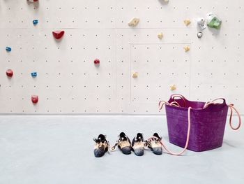 Shoes and basket against climbing wall