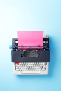 Close-up of pink camera over white background