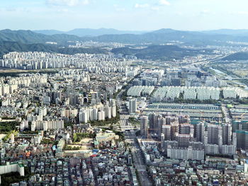 High angle view of city buildings against sky