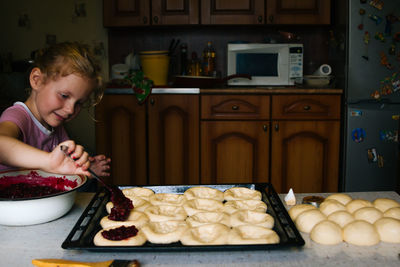 High angle view of boy preparing food in kitchen at home