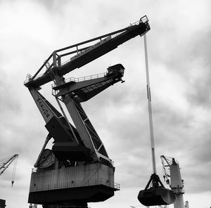Low angle view of crane against sky
