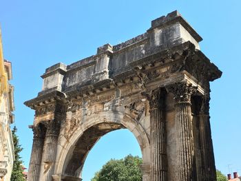 Low angle view of old ruins against clear sky